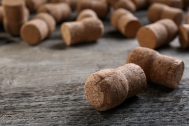 Photo of Sparkling wine bottle corks on wooden table, closeup. Space for text