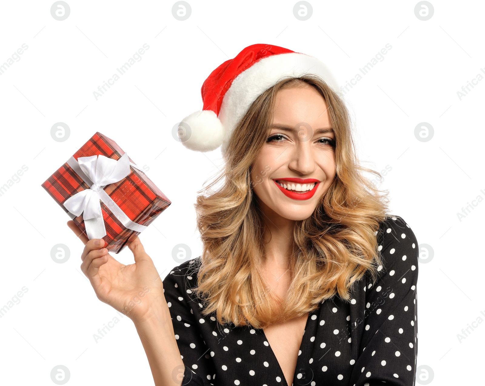 Photo of Happy young woman wearing Santa hat with Christmas gift on white background