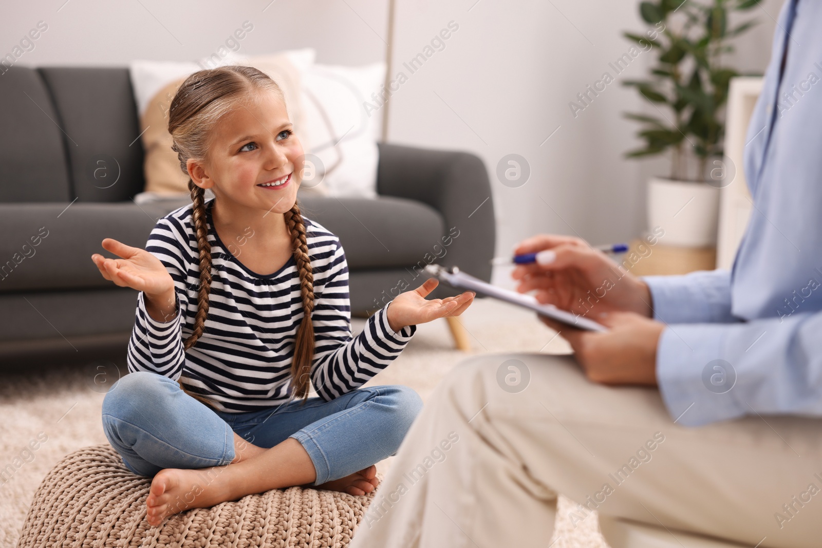 Photo of Dyslexia treatment. Therapist working with girl in room