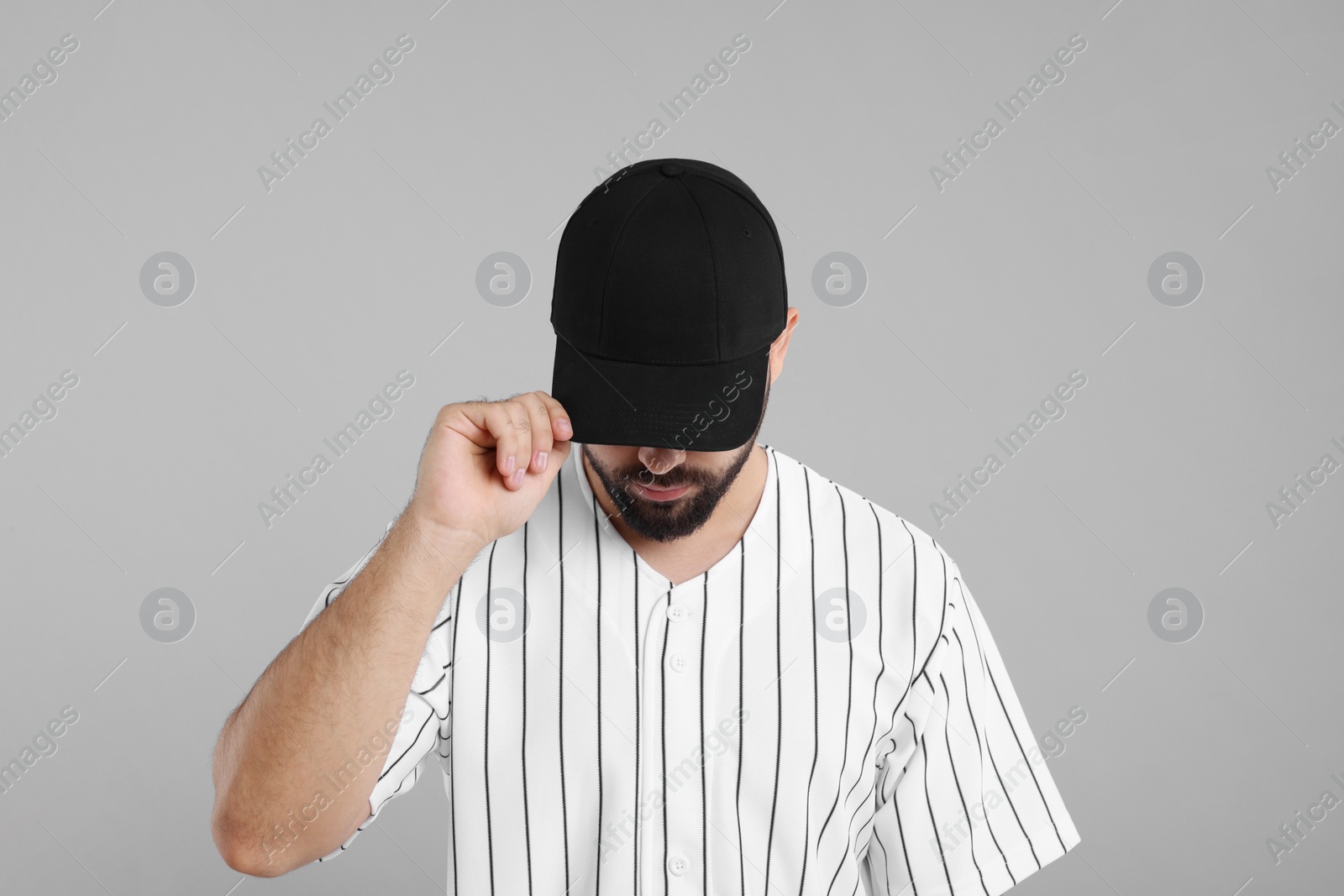 Photo of Man in stylish black baseball cap on light grey background