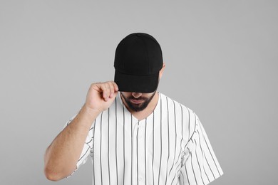 Photo of Man in stylish black baseball cap on light grey background