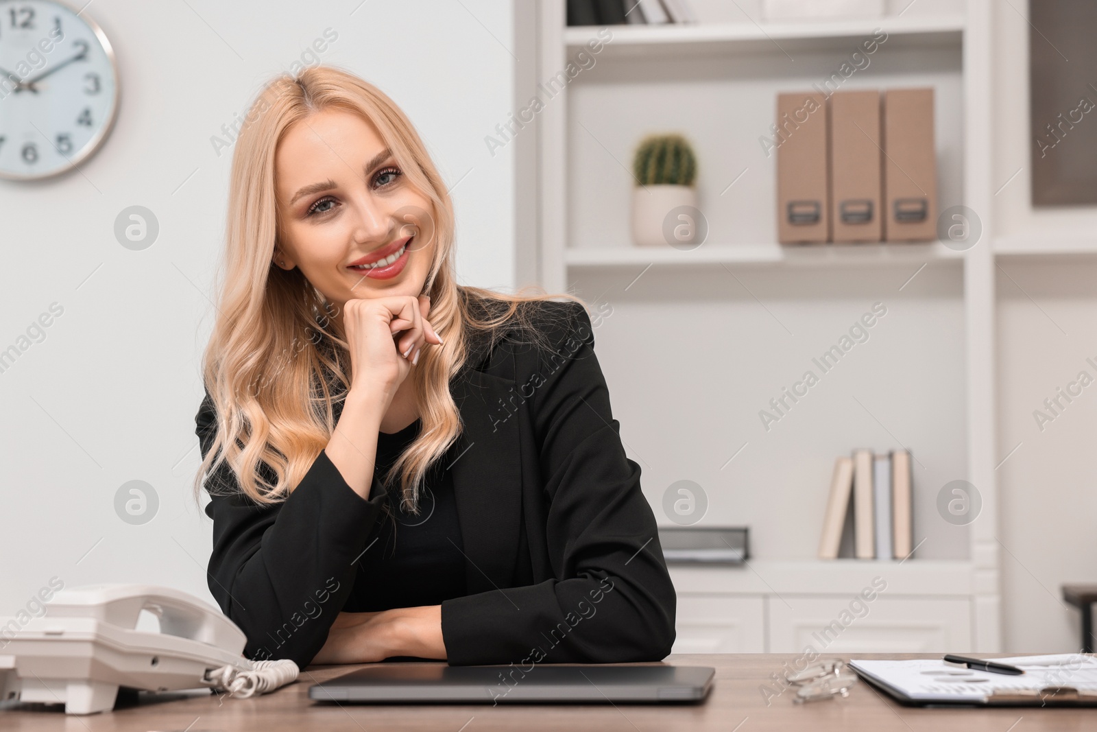 Photo of Happy secretary at table in office, space for text