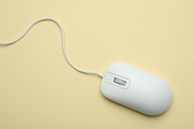 Photo of Wired computer mouse on yellow background, top view