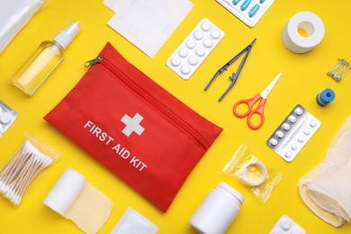 Photo of Flat lay composition with first aid kit on yellow background