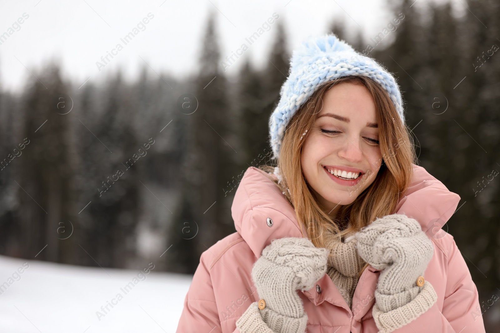 Photo of Young woman in warm clothes outdoors, space for text. Winter vacation