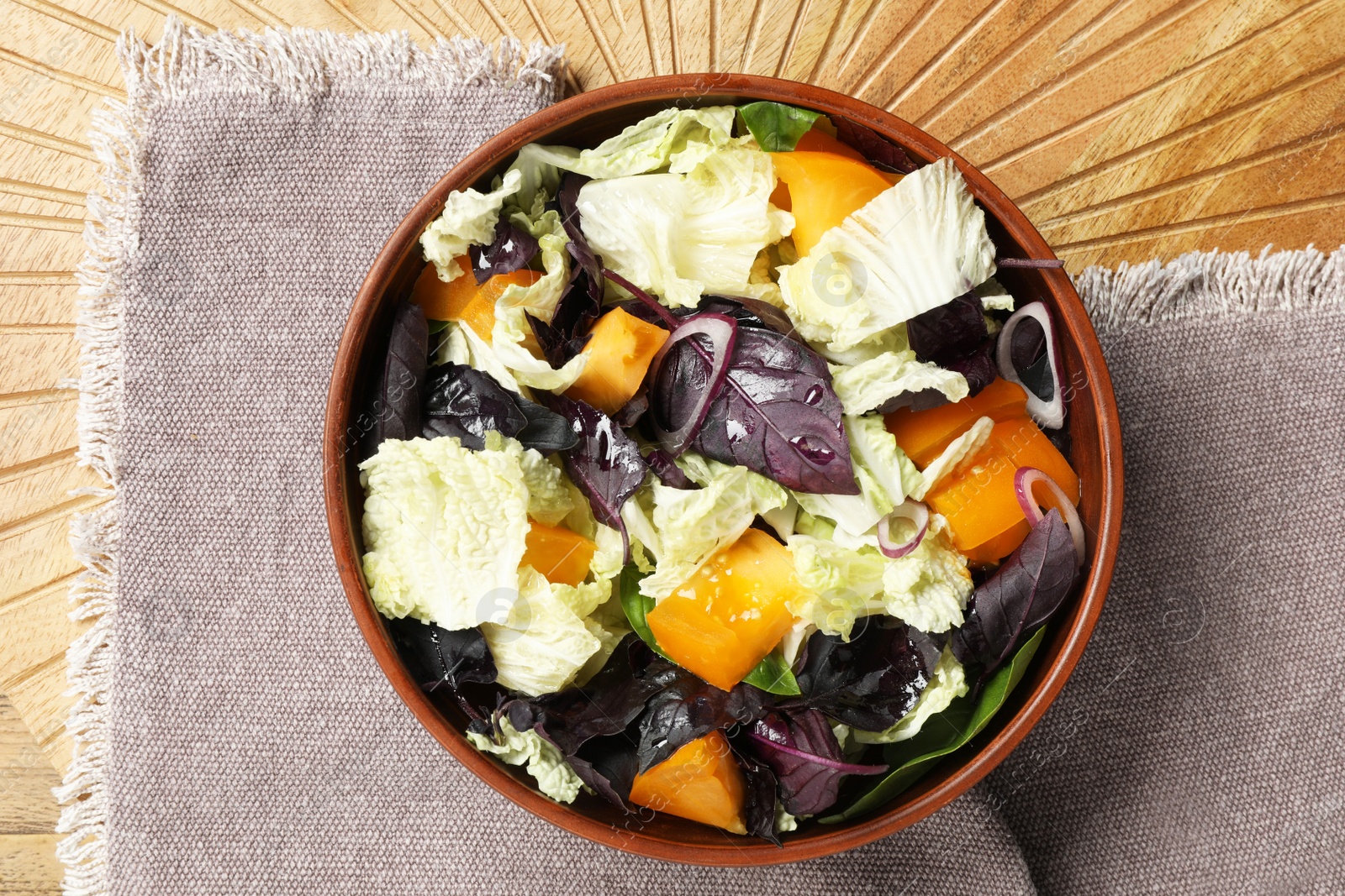 Photo of Delicious salad with Chinese cabbage, tomato and basil on wooden board, top view