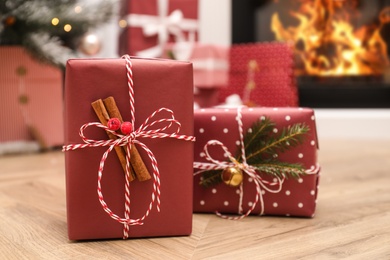 Different beautiful Christmas gifts on floor indoors