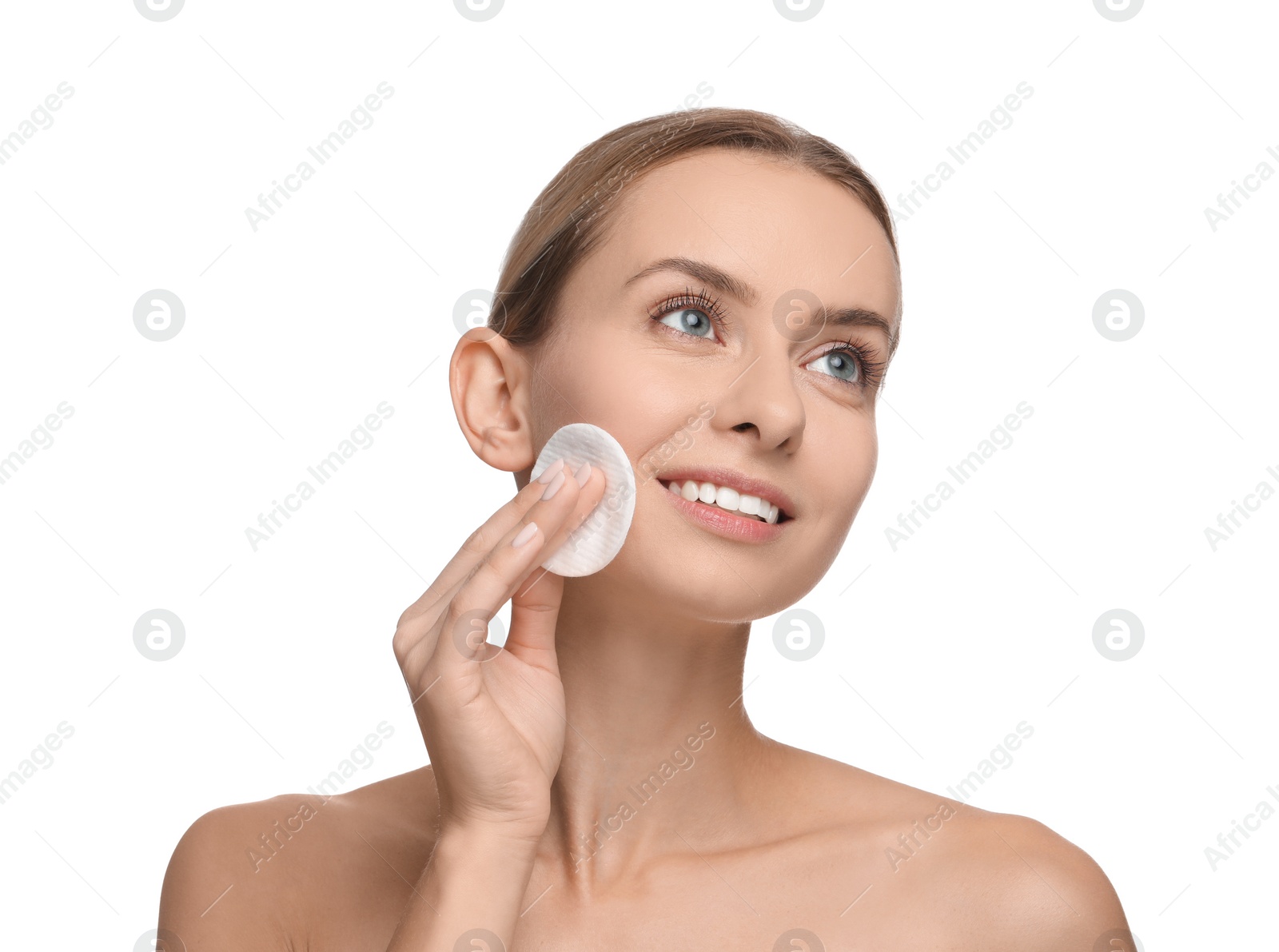 Photo of Smiling woman removing makeup with cotton pad on white background