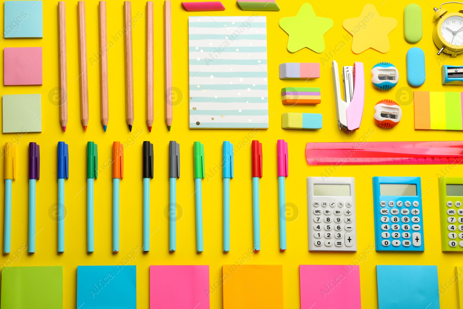 Photo of Flat lay composition with school stationery on yellow background. Back to school