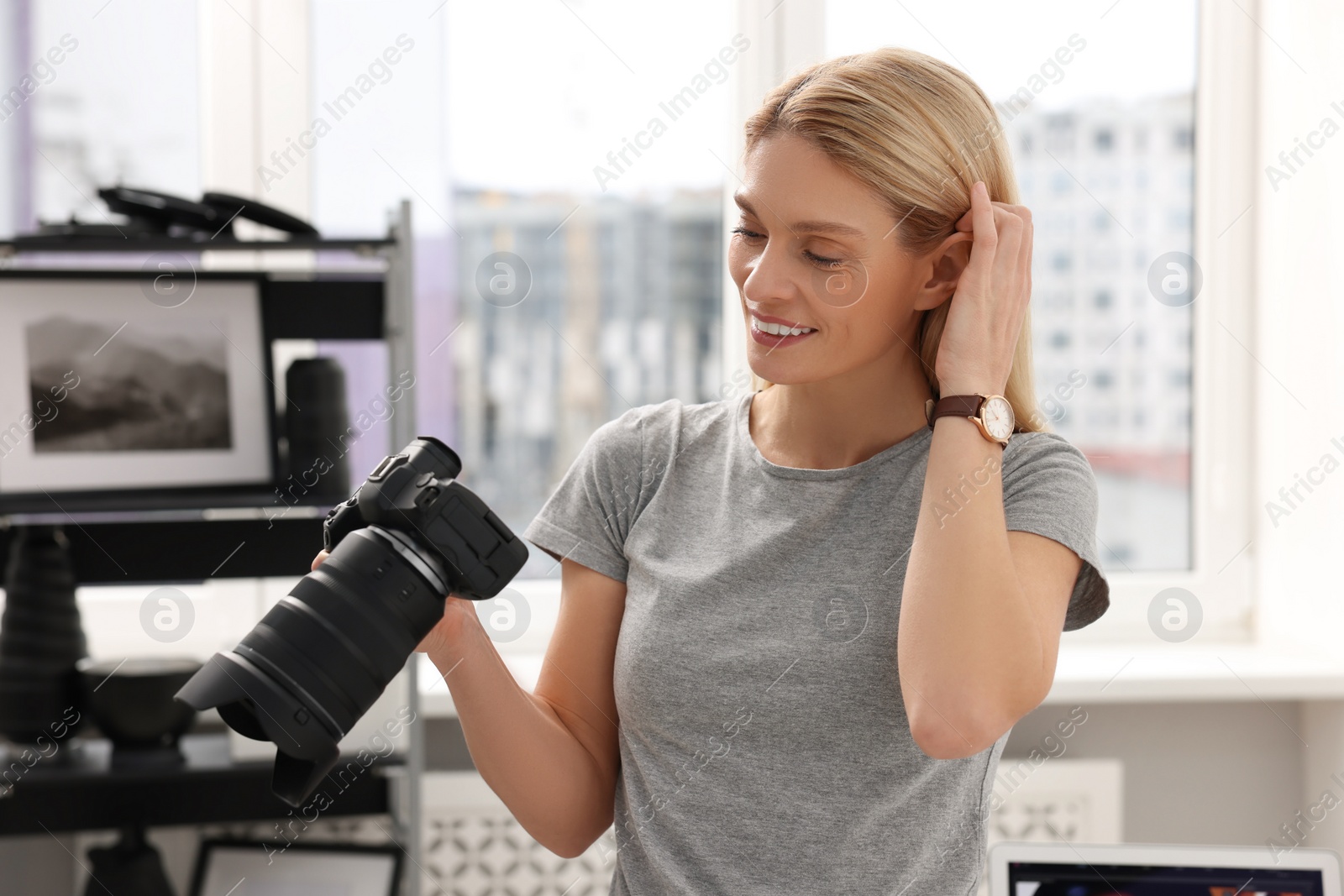 Photo of Professional photographer with modern digital camera in office