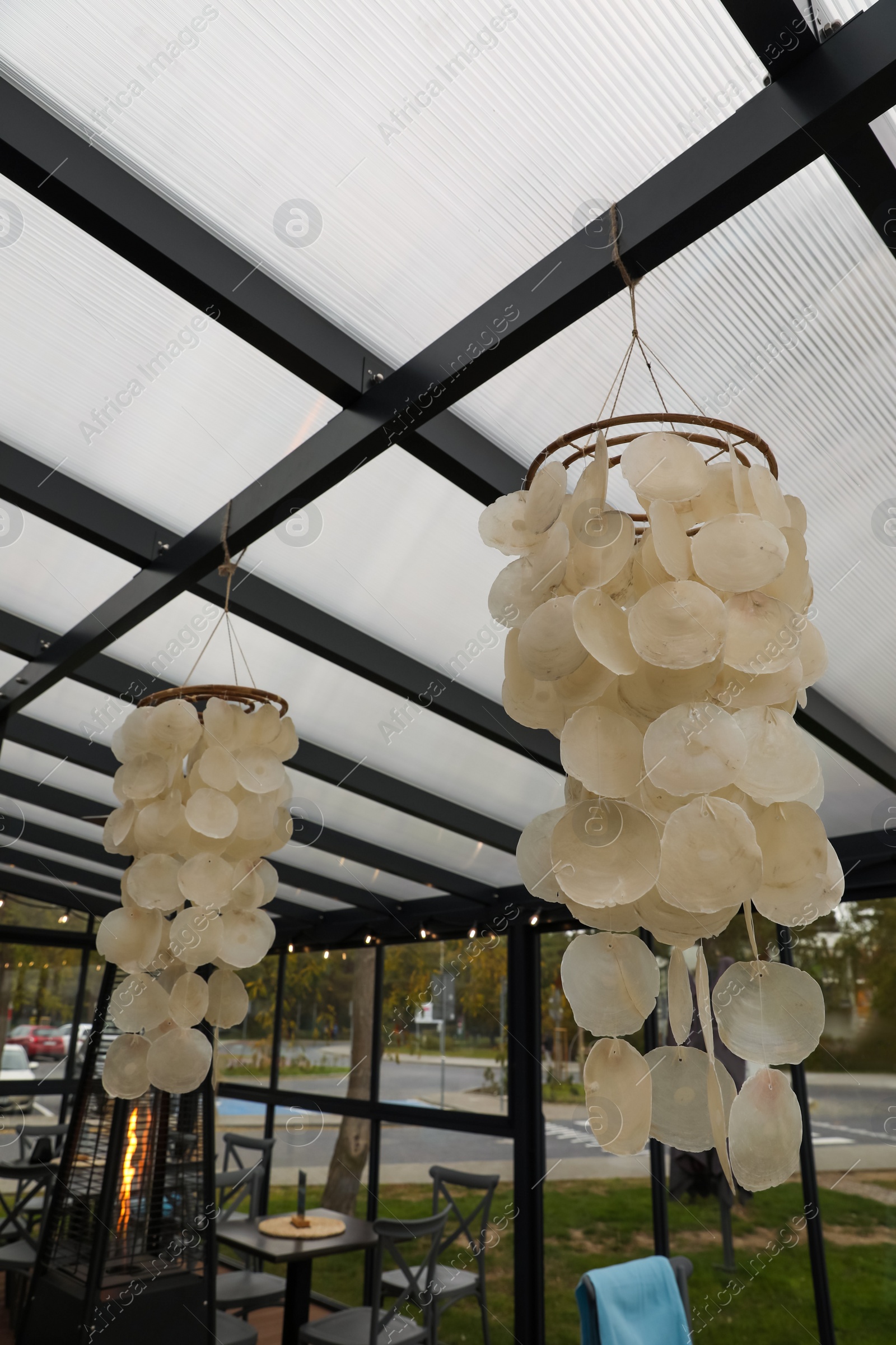 Photo of Beautiful lampshades hanging in stylish restaurant. Real estate