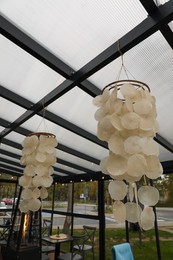 Photo of Beautiful lampshades hanging in stylish restaurant. Real estate