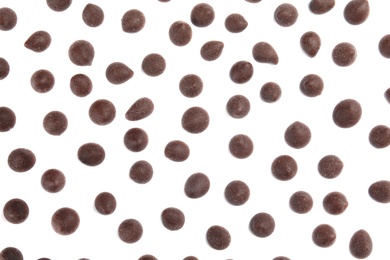 Photo of Delicious dark chocolate chips on white background, flat lay