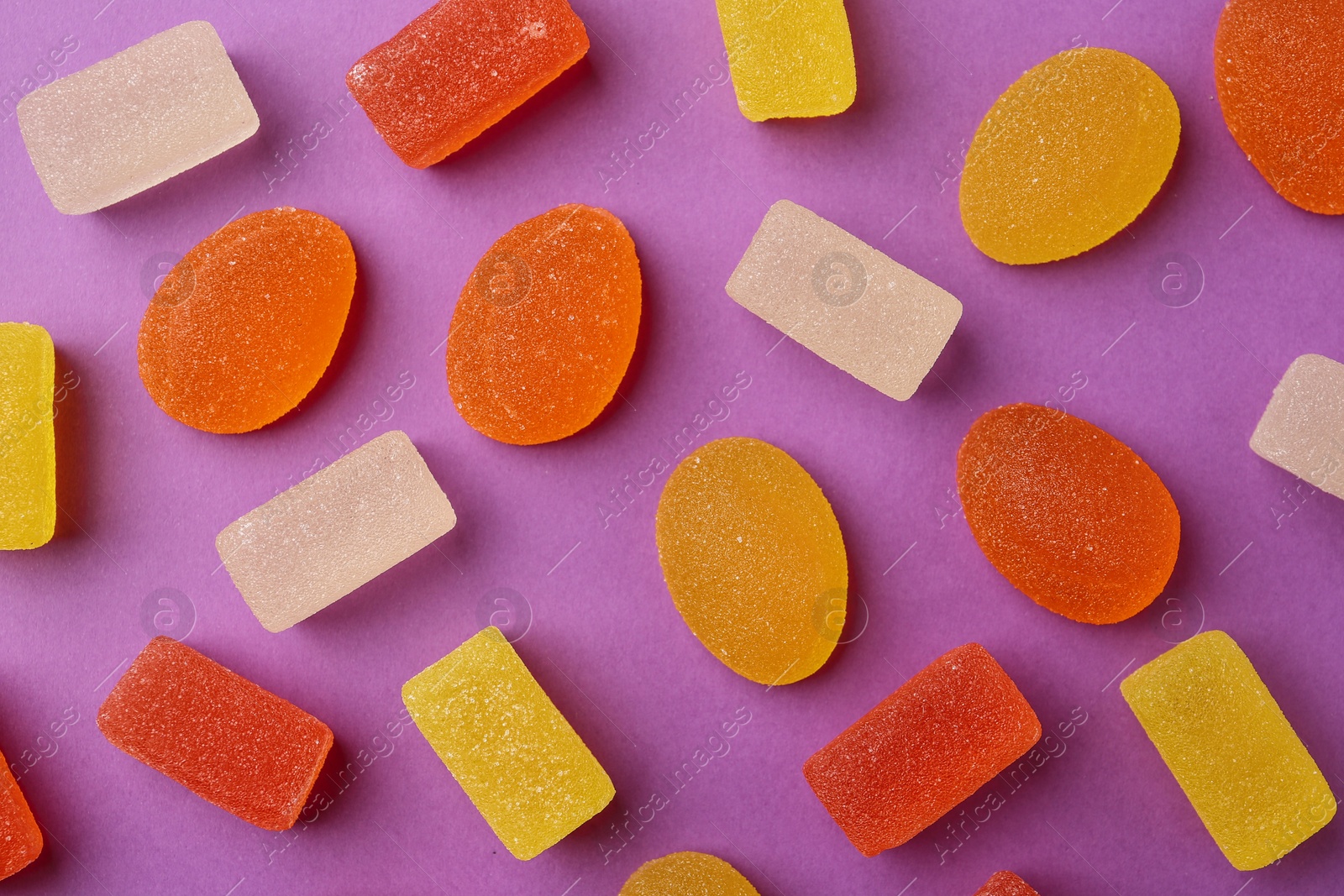 Photo of Flat lay composition with delicious jelly candies on color background