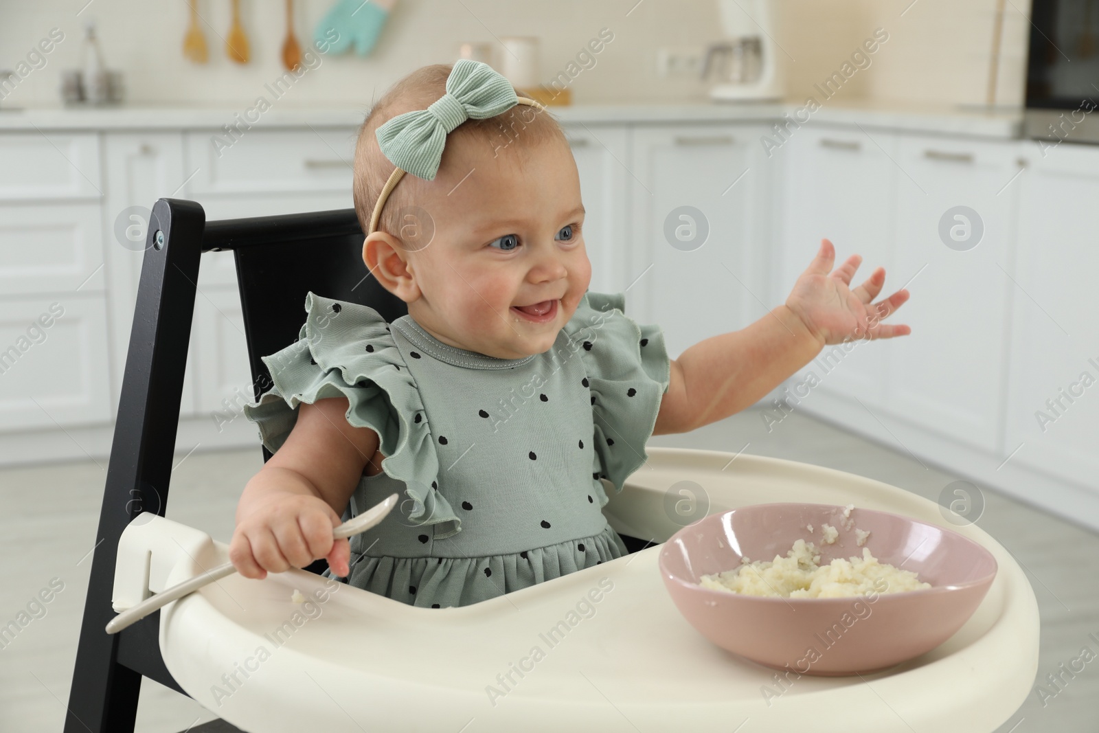 Photo of Cute little girl eating healthy food at home