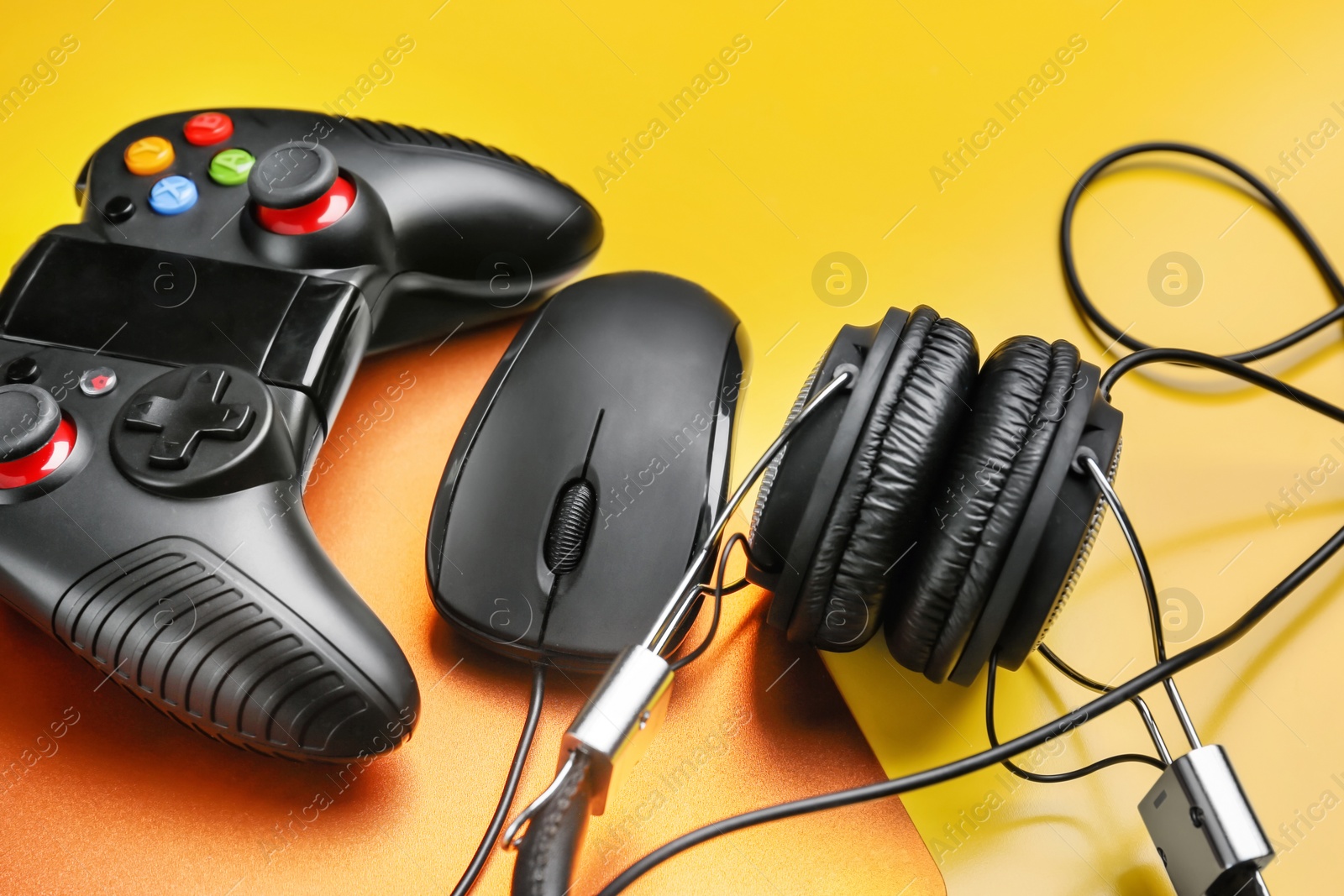 Photo of Composition with computer mouse and gaming gear on color background