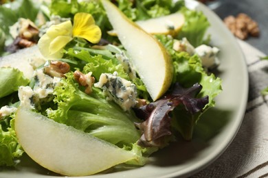 Photo of Fresh salad with pear on table, closeup