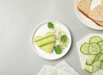 Photo of Flat lay composition with traditional English cucumber sandwich and ingredients on grey background. Space for text