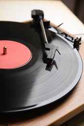 Photo of Modern vinyl record player with disc, closeup
