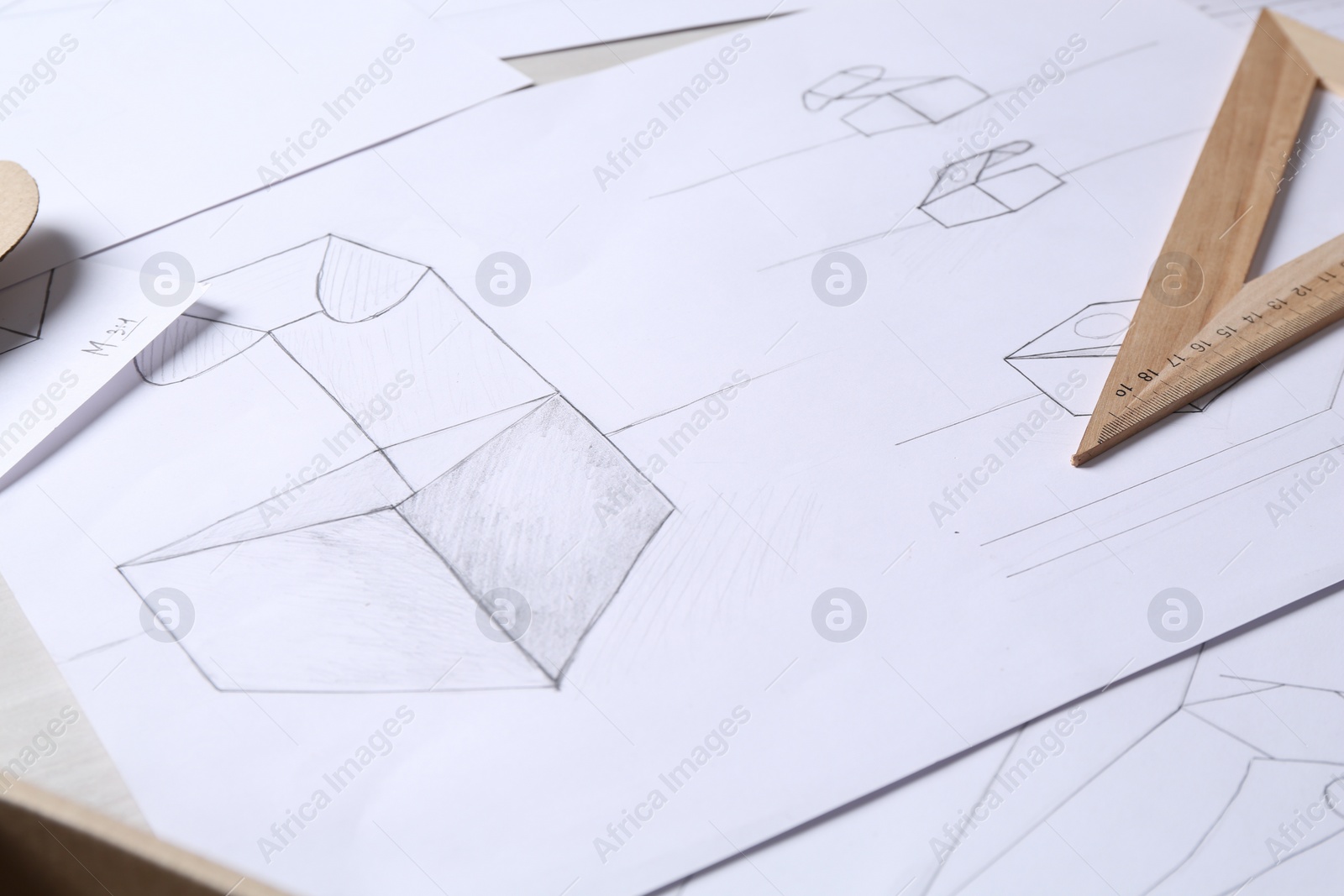 Photo of Creating packaging design. Drawings and ruler on table, closeup