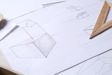 Photo of Creating packaging design. Drawings and ruler on table, closeup