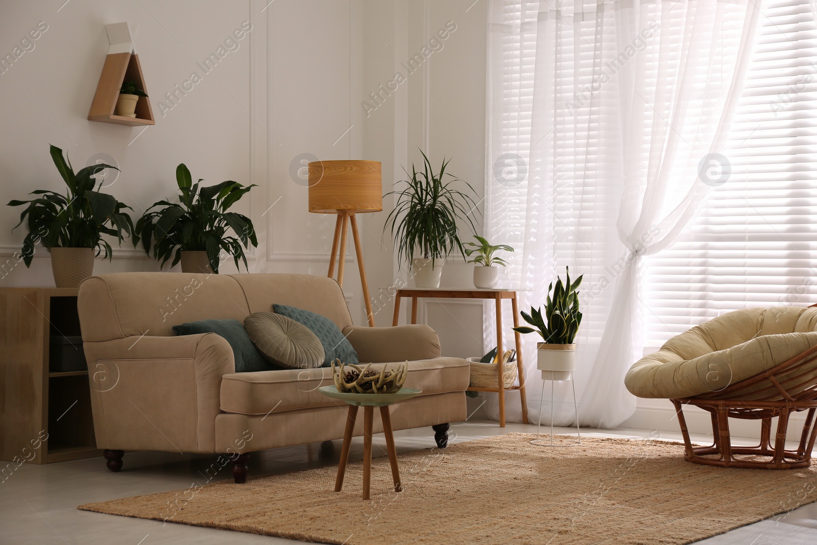 Photo of Stylish living room interior with comfortable sofa and cushions