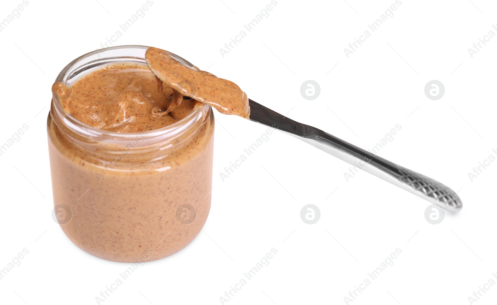 Photo of Tasty nut paste in jar and knife isolated on white