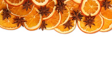 Dry orange slices and anise stars on white background, flat lay. Space for text