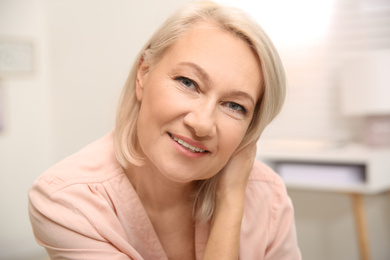 Portrait of beautiful mature woman at home