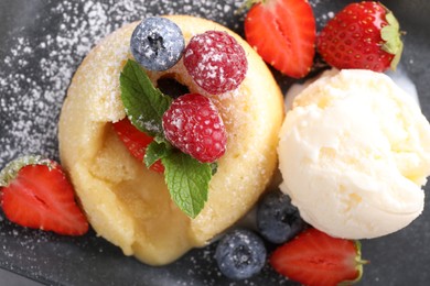 Tasty vanilla fondant with white chocolate, berries and ice cream on table, flat lay