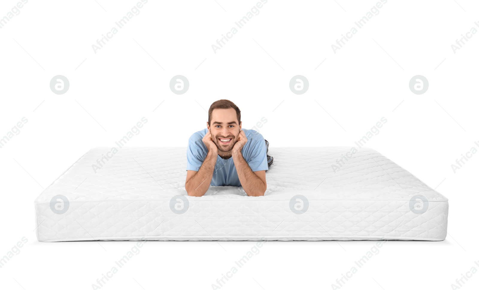 Photo of Young man lying on mattress against white background