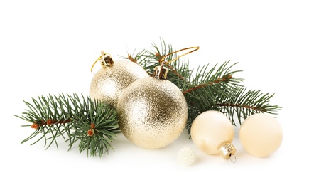 Beautiful Christmas balls and fir branch on white background