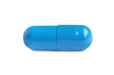 Photo of One light blue pill on white background. Medicinal treatment