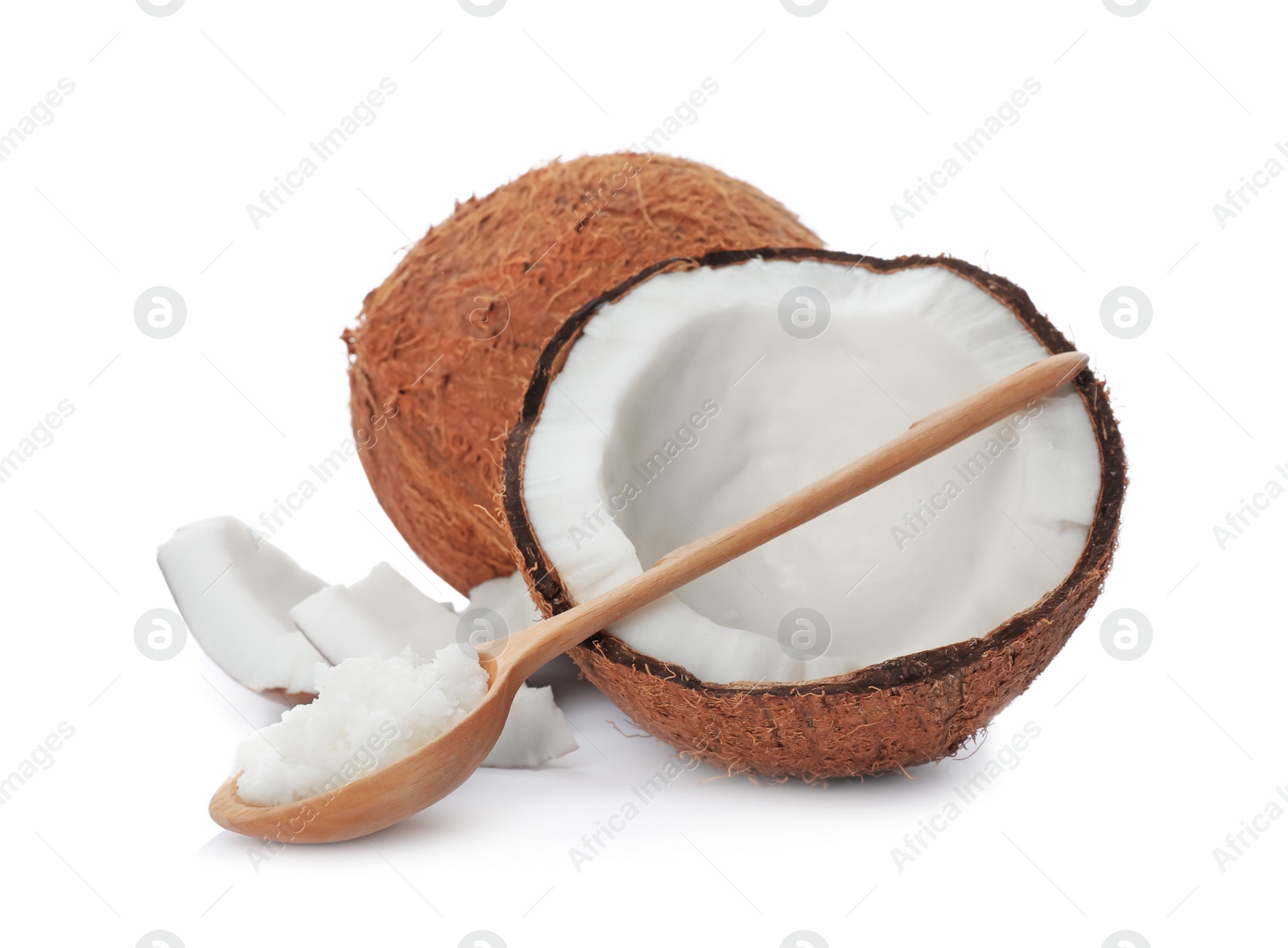 Photo of Ripe coconut and spoon with oil on white background. Healthy cooking