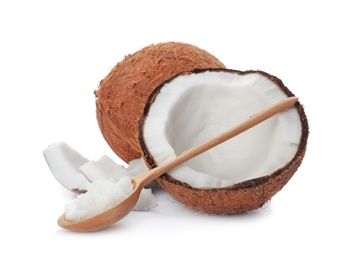 Photo of Ripe coconut and spoon with oil on white background. Healthy cooking