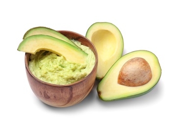 Bowl with guacamole and ripe avocado on white background