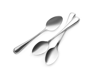 Photo of Clean shiny metal spoons on white background, top view