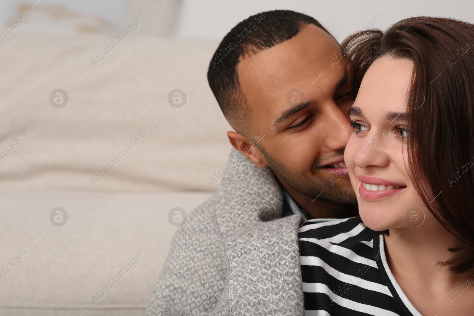 Photo of Dating agency. Man kissing his girlfriend indoors, space for text