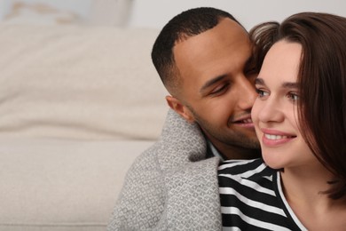 Photo of Dating agency. Man kissing his girlfriend indoors, space for text