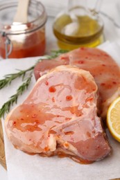 Photo of Pieces of raw marinated meat on table, closeup