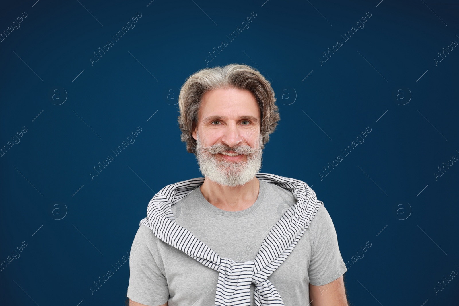 Photo of Portrait of handsome mature man on blue background