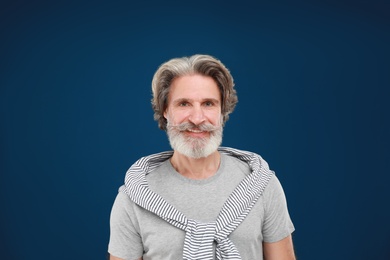 Photo of Portrait of handsome mature man on blue background