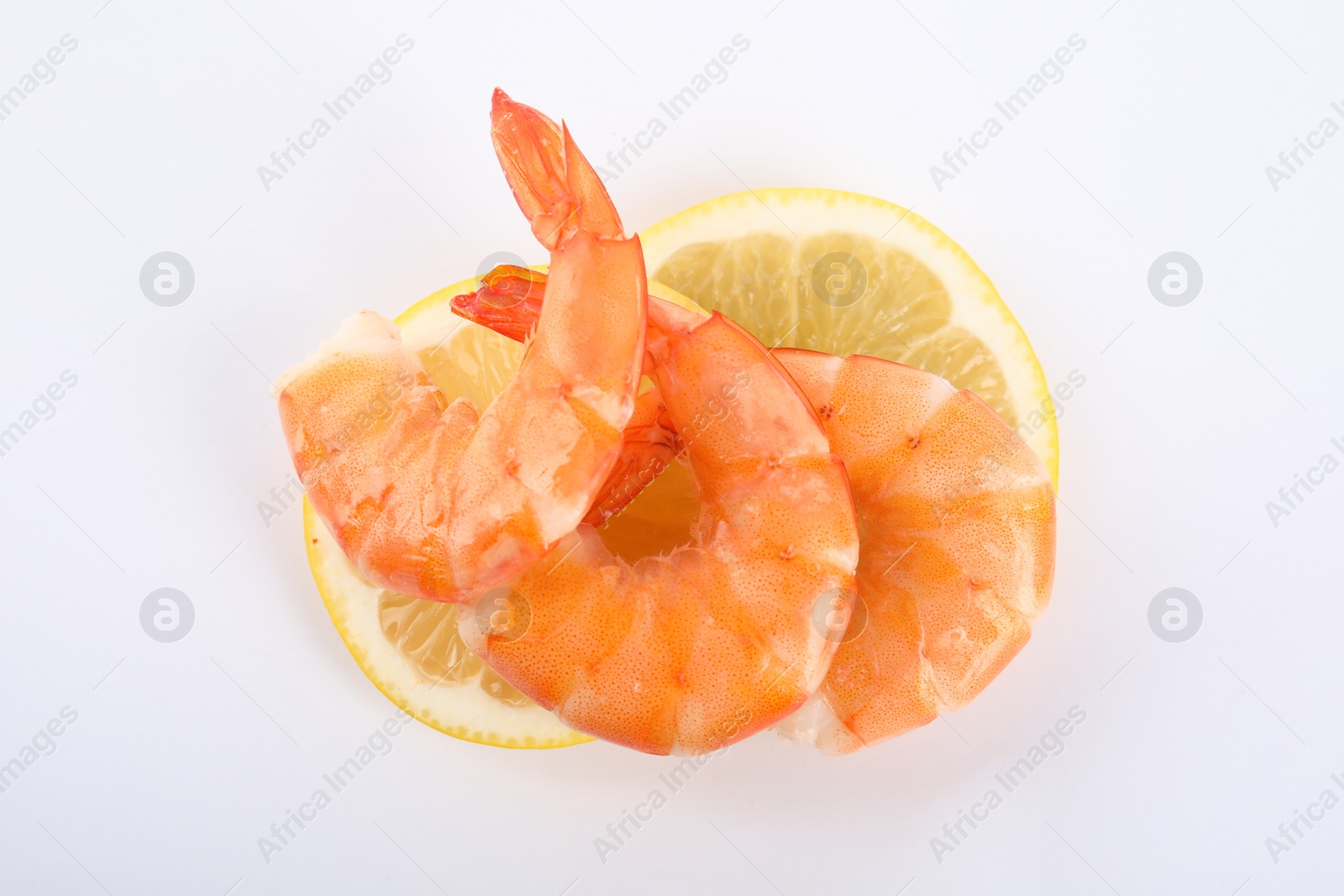 Photo of Delicious cooked shrimps and lemon isolated on white, top view