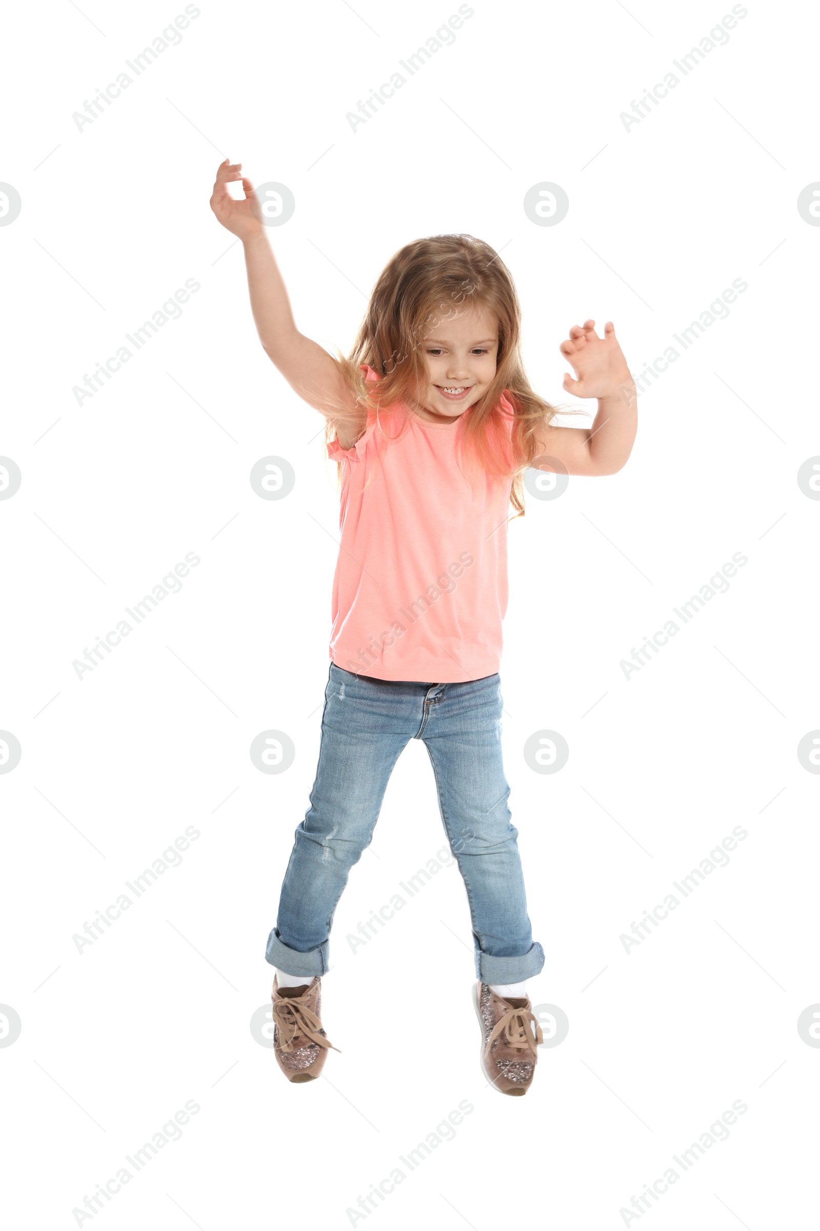 Photo of Pretty little girl jumping against white background