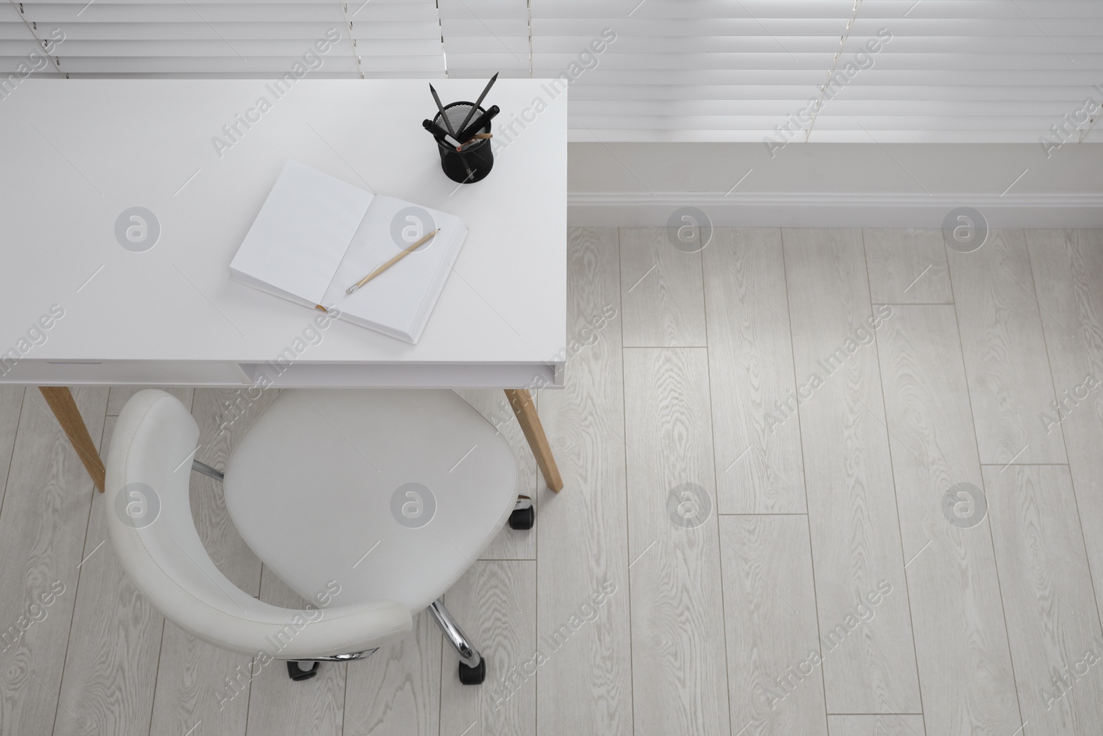 Photo of Stylish workplace with white desk and comfortable chair near window indoors, above view. Interior design