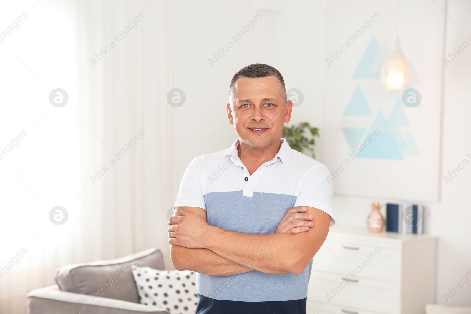 Photo of Portrait of mature man in living room