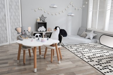 Photo of Montessori bedroom interior with floor bed and toys