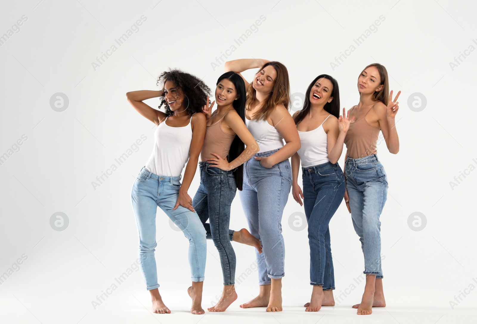 Photo of Group of women with different body types on light background