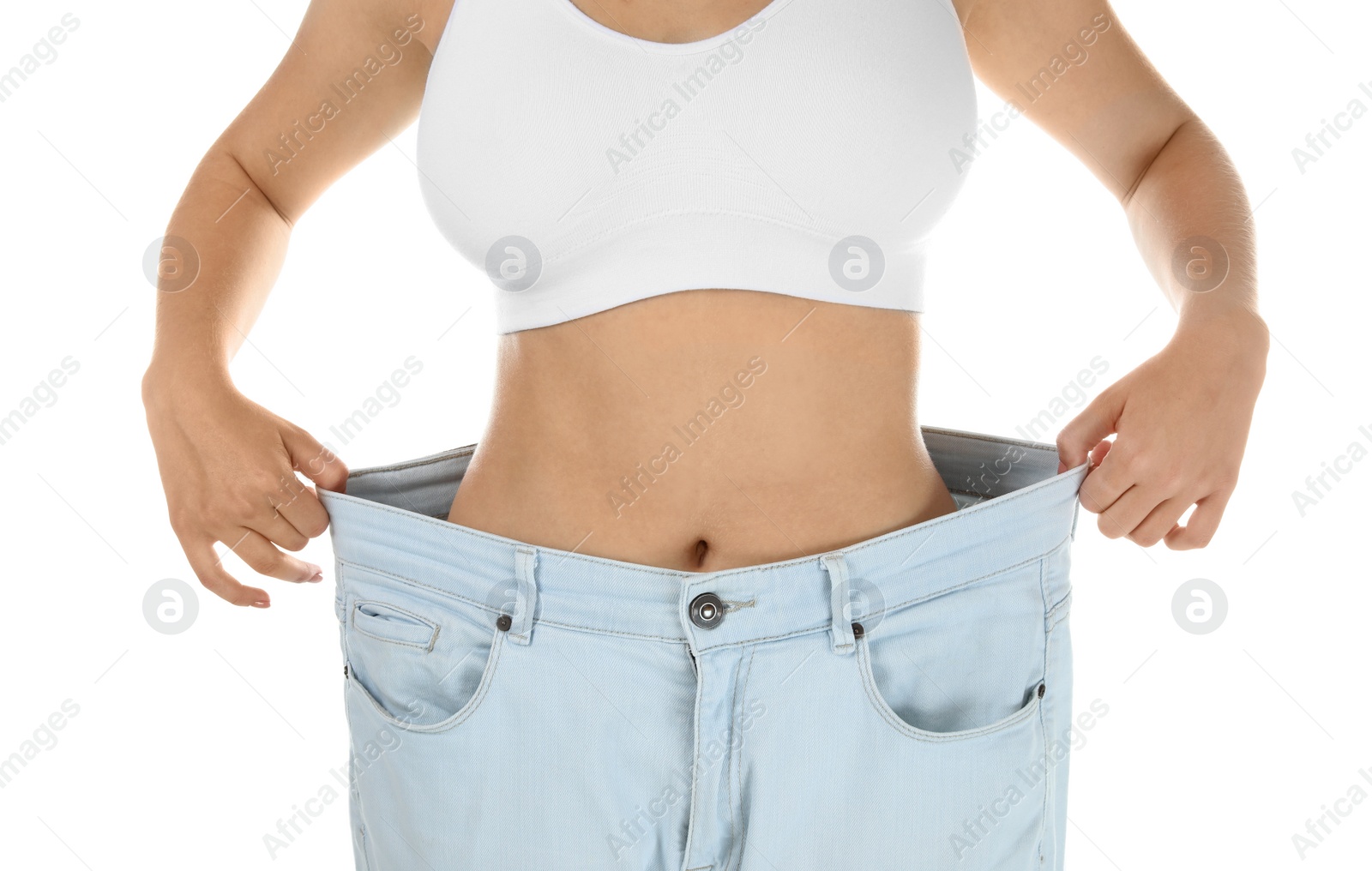 Photo of Young woman wearing oversize pants on white background. Healthy diet
