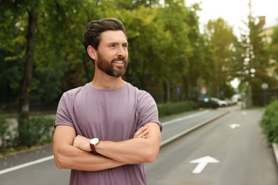 Portrait of handsome bearded man on street, space for text